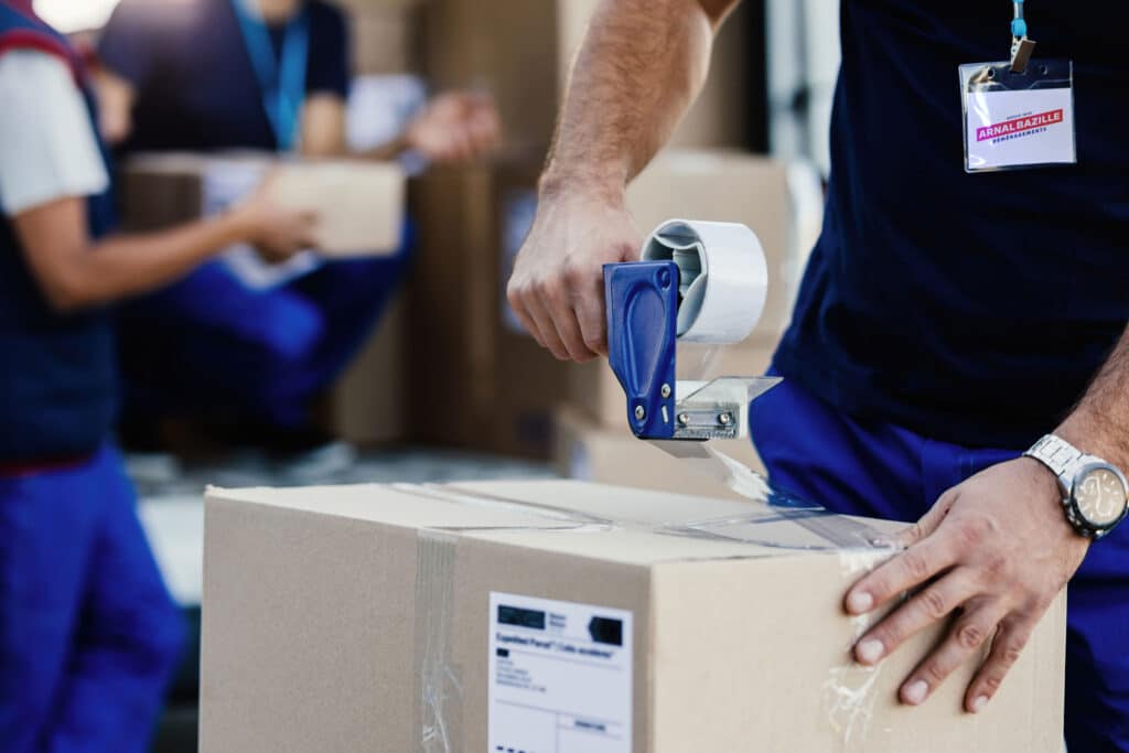déménageur fermant carton